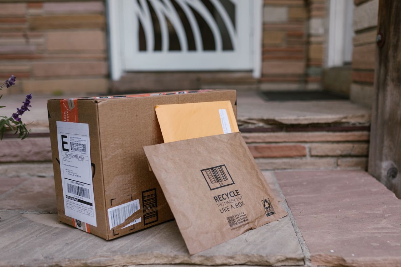 services-01 Close-up of delivered packages on doorstep, symbolizing online shopping and home delivery.